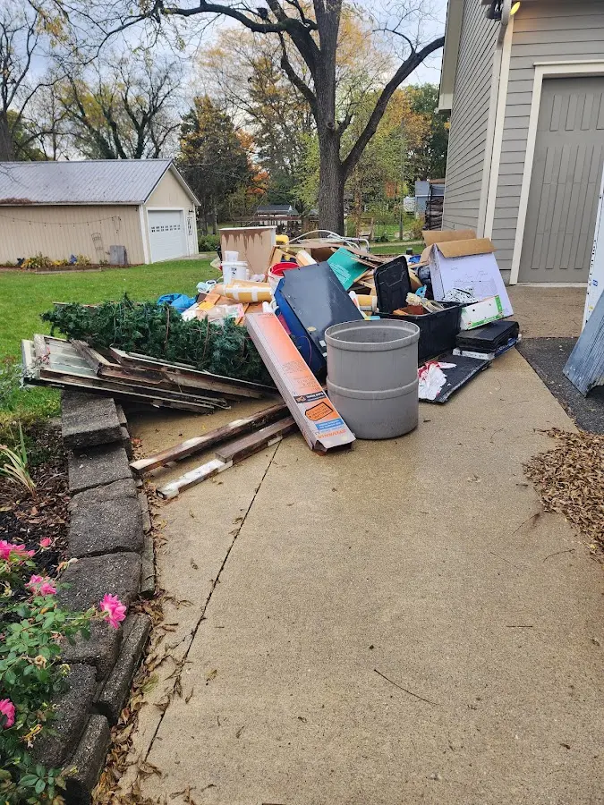 Dumpster being loaded with debris for Residential Dumpster Rental in Huron